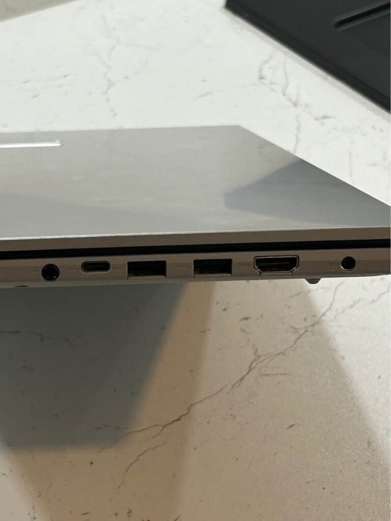 ASUS Vivobook Core i7 laptop side view displaying right panel ports including 3.5mm audio jack, USB-C port, two USB-A ports, full-size HDMI port, and a 3.5mm DC jack in silver chassis finish
