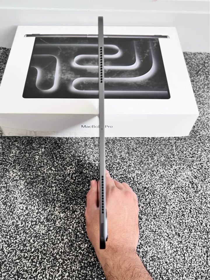 Apple iPad Pro 13-inch M5 side profile view showcasing the precision-drilled speaker grilles and USB-C port on the Space Black aluminum chassis
