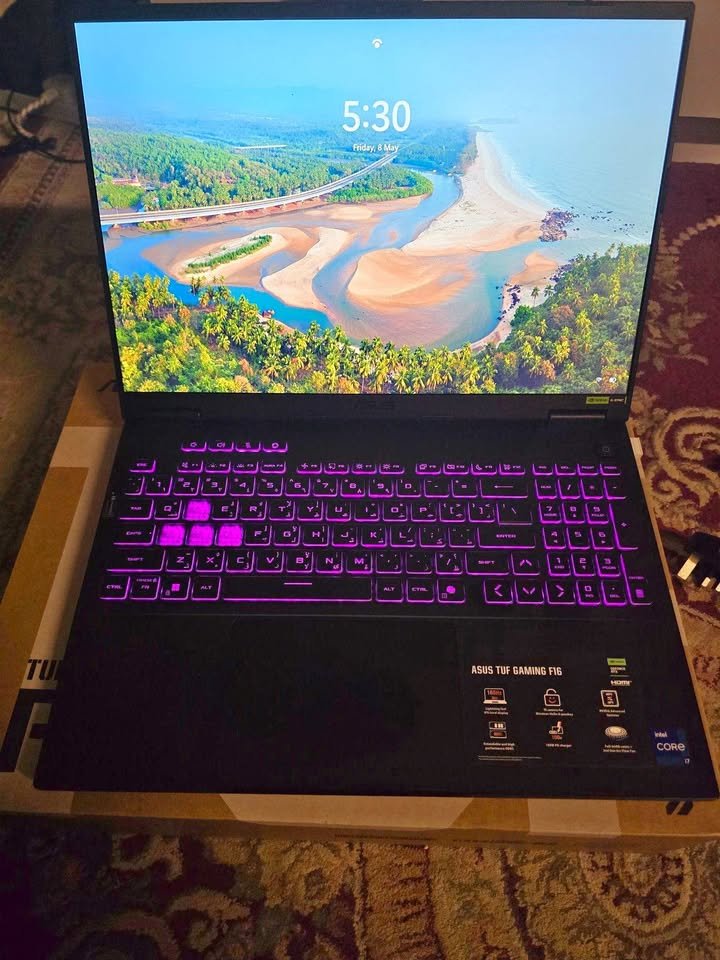 ASUS TUF Gaming F16 laptop powered by Intel Core i7-14650HX processor and NVIDIA GeForce RTX 5060 GPU, featuring a full-size RGB backlit keyboard with vibrant purple illumination and a 16-inch FHD display in open position