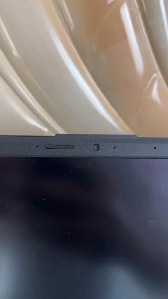 ASUS Vivobook Core i7 laptop top bezel close-up view highlighting the built-in privacy webcam physical shutter in the off or closed position with integrated IR camera and microphone array