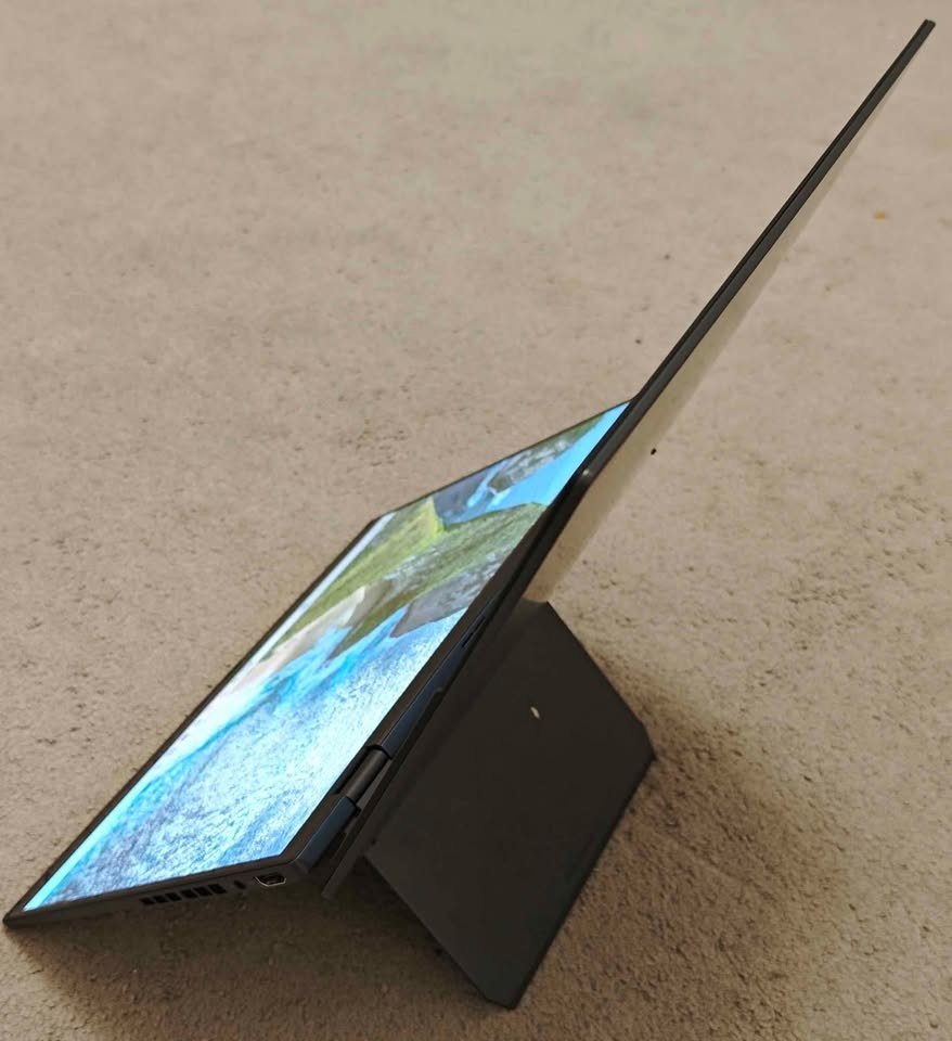 ASUS Zenbook Duo Intel Core Ultra 7 laptop displayed in standing tent mode, slim bezels, dual-hinge design, and ultra-thin profile from a side-angle view