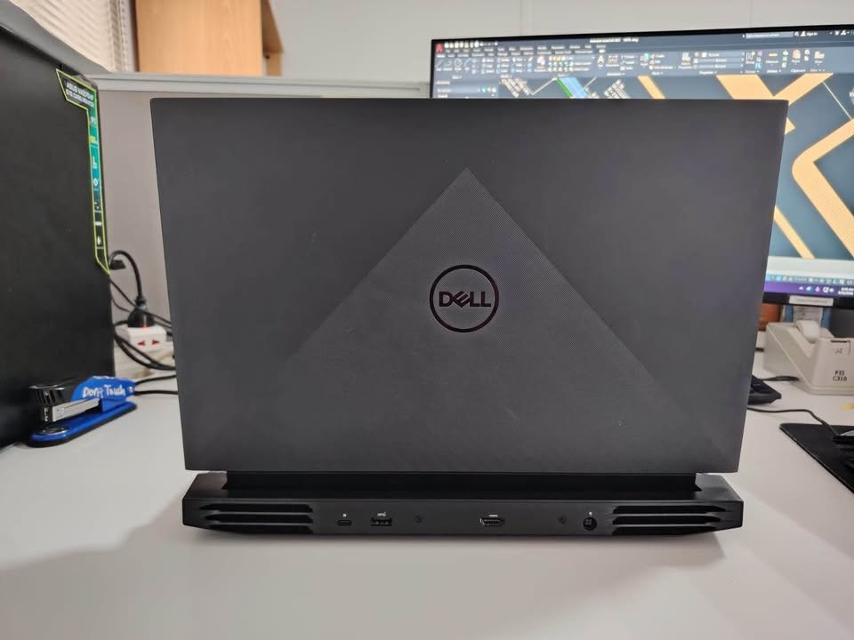 Dell G15 gaming laptop rear view showcasing the back panel with USB-C, USB-A, and HDMI ports, reinforced hinge design, and dual-side ventilation grilles for thermal cooling