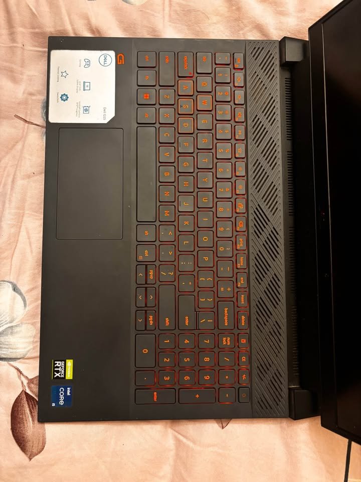 Dell G15 Gaming Laptop with Intel Core i5 and NVIDIA RTX GPU featuring orange backlit keyboard and right-side speaker grille top view