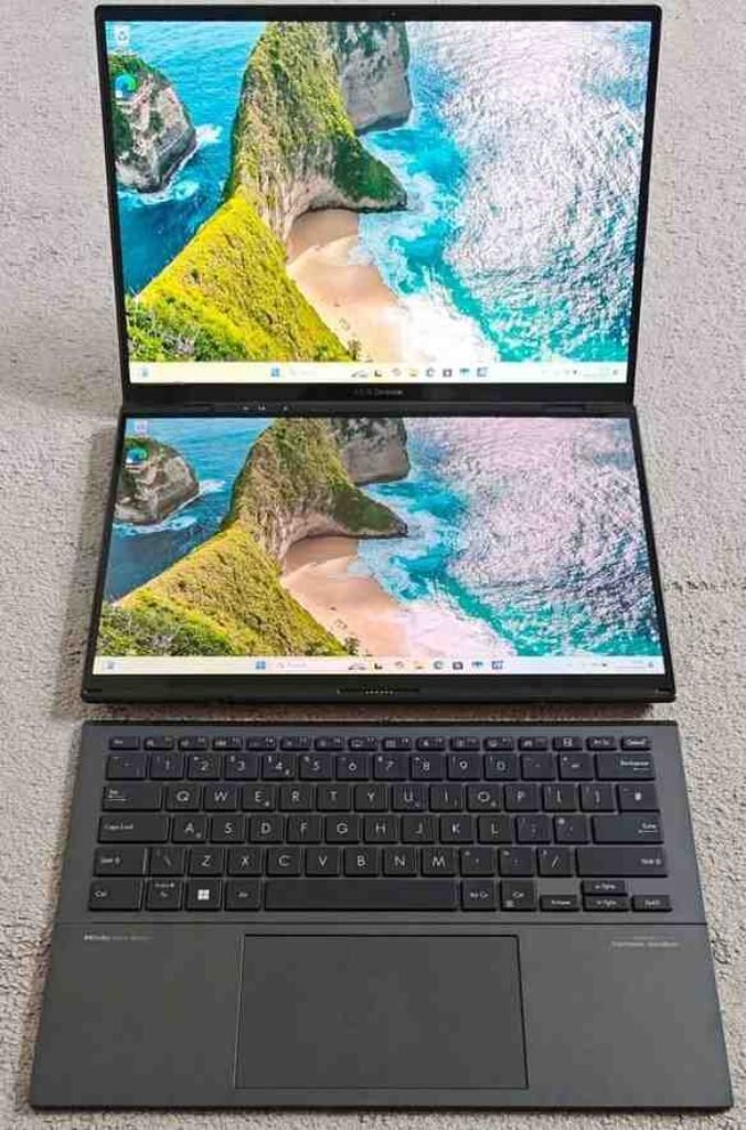 ASUS Zenbook Duo Intel Core Ultra 7 dual-screen laptop with detachable keyboard, showcasing twin 14-inch OLED displays running Windows 11 and a full-size backlit keyboard — front open view