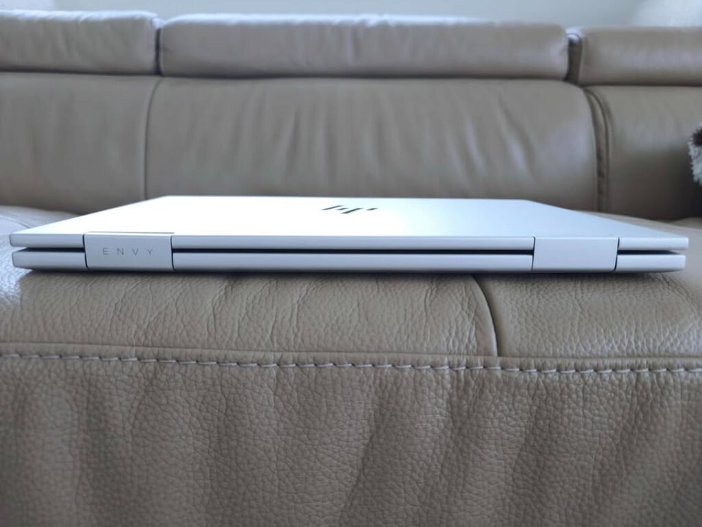 HP Envy x360 laptop closed side profile view showcasing the slim dual-hinge design and premium silver aluminum build.