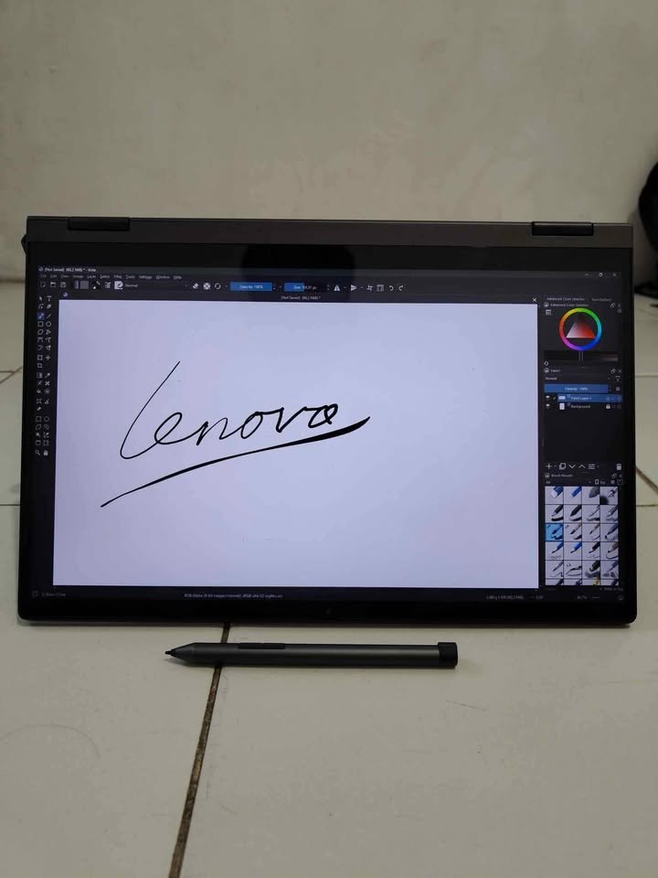 Lenovo IdeaPad 5 2-in-1 display mode showing a handwritten "Lenovo" signature drawn with the active stylus pen inside Krita digital painting software, demonstrating the laptop's precision touchscreen and active pen input capability