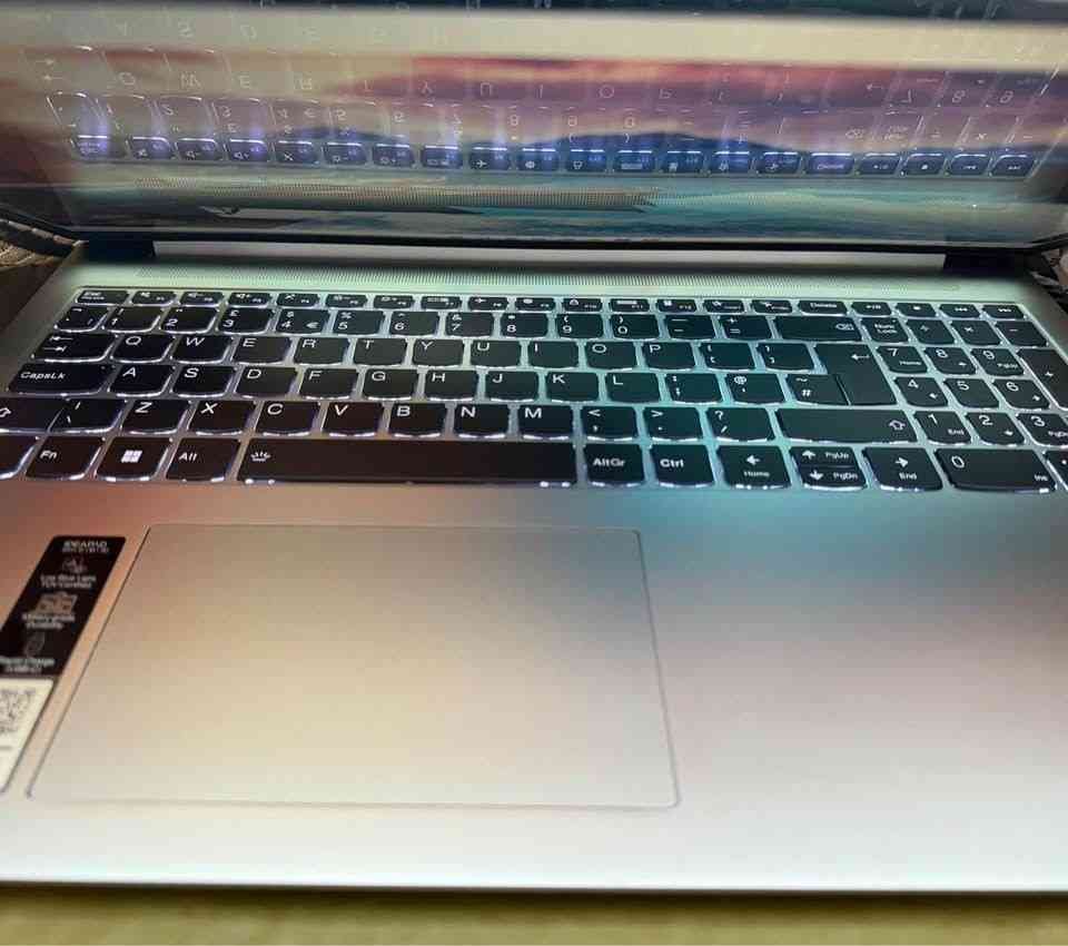 Lenovo IdeaPad Slim 3 Core i7 Laptop featuring a white backlit keyboard with full numeric keypad and large precision trackpad, aerial close-up view