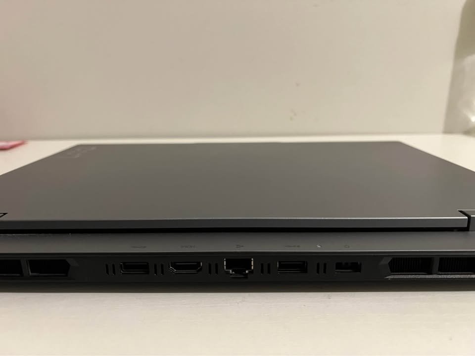 Lenovo LOQ Gaming Laptop rear panel view showing dual USB-A ports, HDMI port, RJ45 Ethernet port, power input, and dual ventilation grilles on AMD Ryzen 7 RTX model in Eclipse Black finish