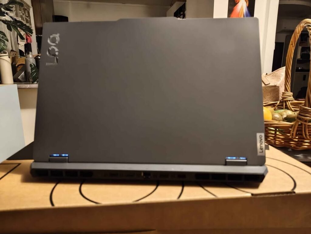 Lenovo LOQ Gaming Laptop AMD Ryzen 7 RTX rear view showcasing matte gray polycarbonate chassis with reinforced hinge frame and wide rear exhaust vent grille