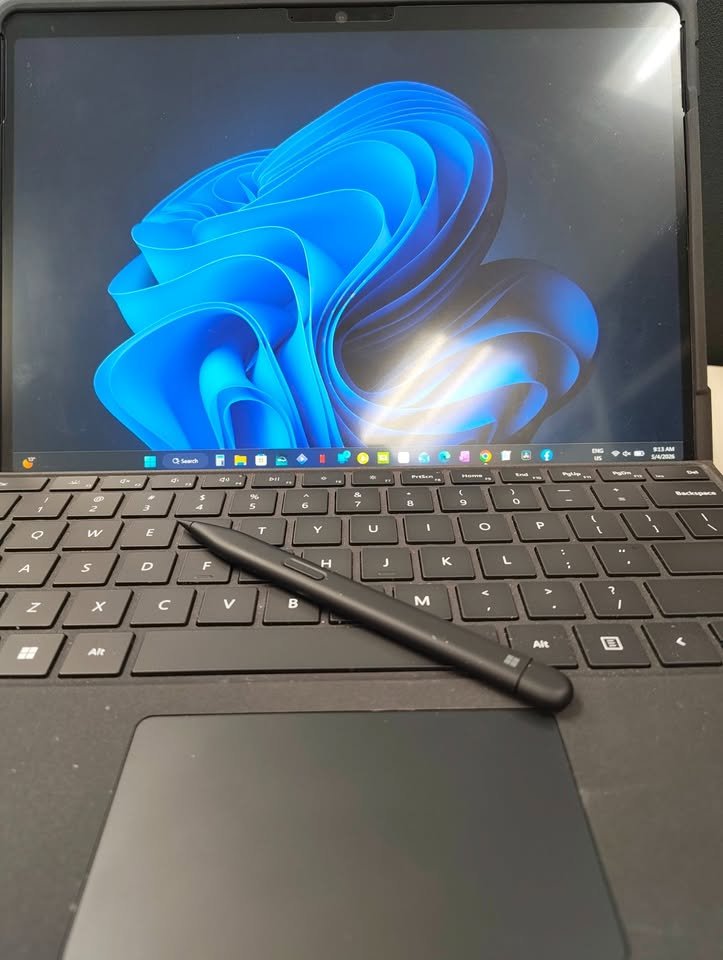 Microsoft Surface Pro 11 2-in-1 laptop open Surface Slim Pen 2 resting on the Surface Pro Flex Keyboard in matte black finish