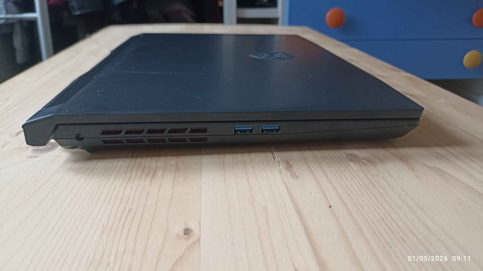 MSI Katana 15 gaming laptop left side view displaying dual USB 3.0 Type-A ports and ventilation grille with MSI branding on lid closed