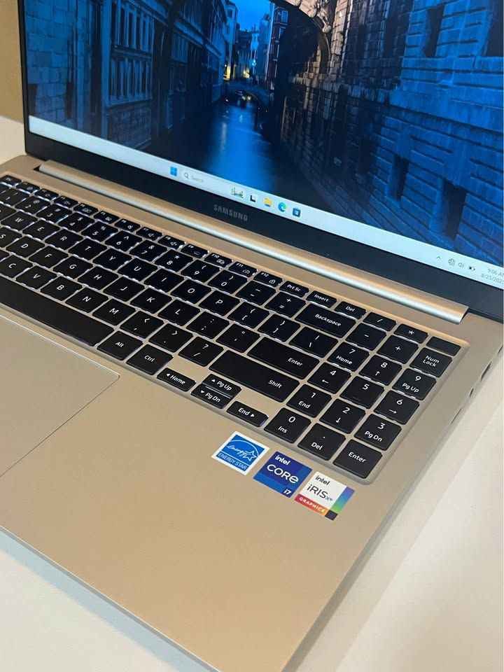 Samsung Galaxy Book 4 Intel Core i7 laptop showcasing the slim gold aluminum body, robust hinge and vibrant Full HD display running Windows 11